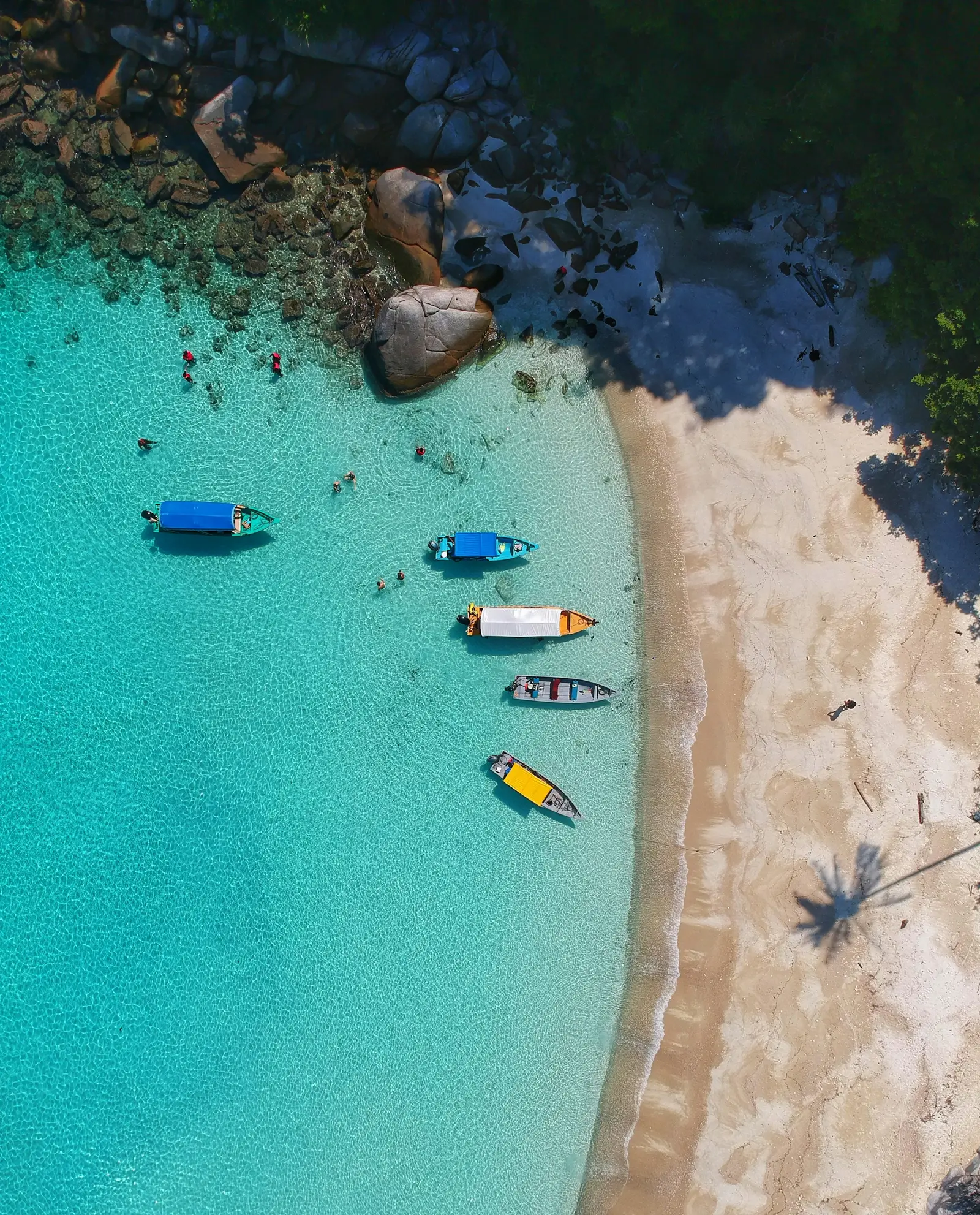 Aerial view of a turquoise lagoon and white sand beach